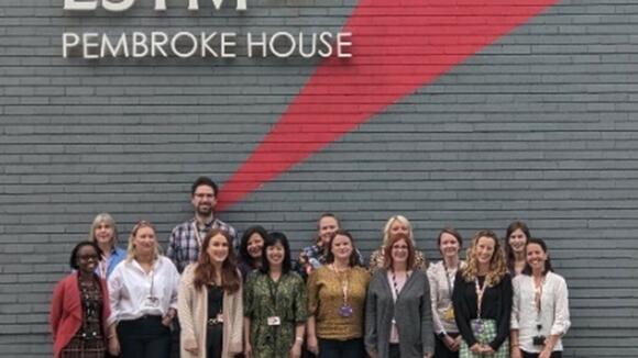 Research support staff in front of Pembroke house